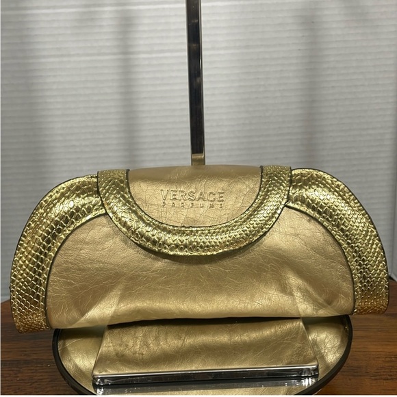 Versace Handbags - NWOT VERSACE LEATHER CLUTCH GOLD METALLIC